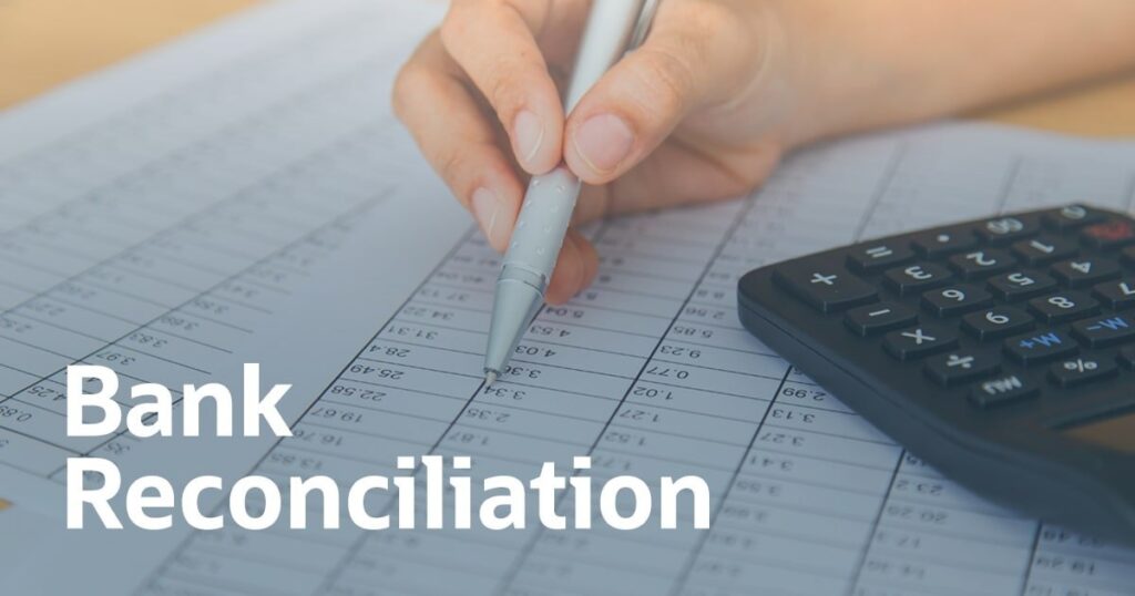 Person performing bank reconciliation with a pen and calculator